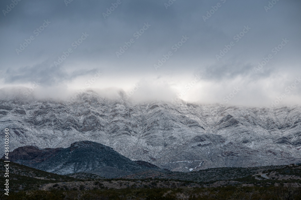 Low lying clouds and snow cover the Franklin Mountains in El Paso Texas. 