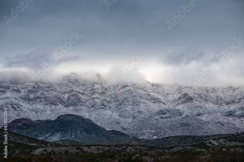 Low lying clouds and snow cover the Franklin Mountains in El Paso Texas. 