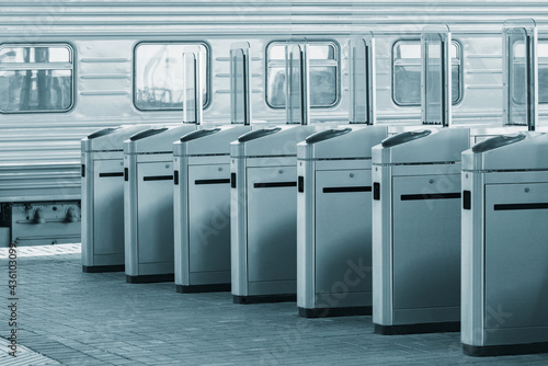 Turnstiles with electronic card readers on the platform.
