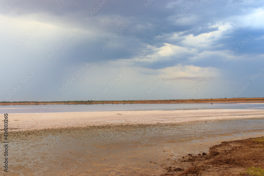 Dark storm clouds over a salt lake before a rain