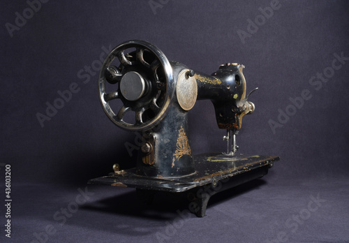 Old sewing machine on a dark background
