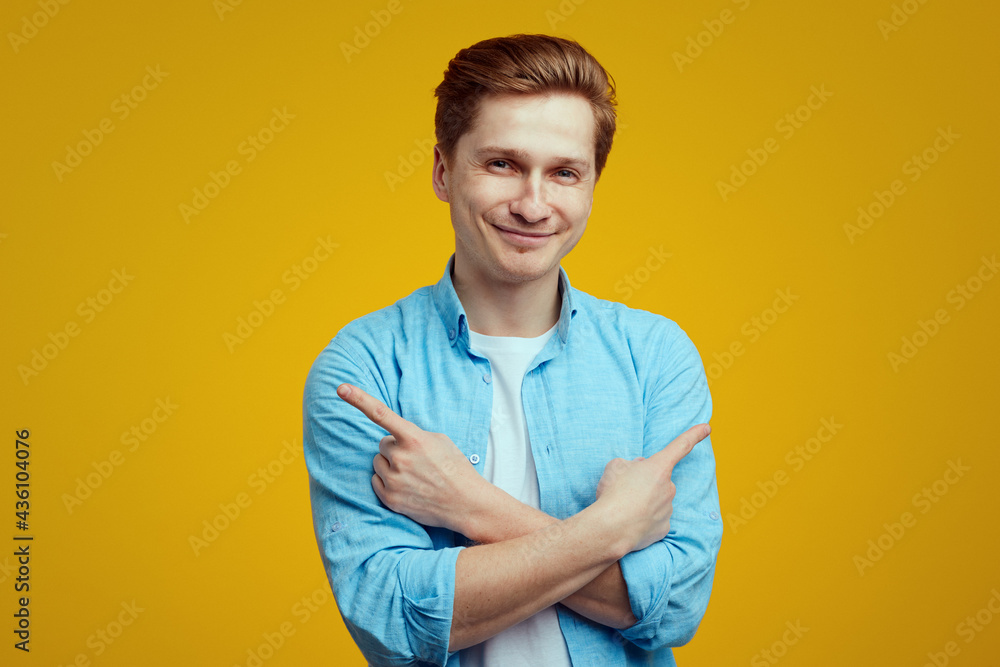 Smiling man crosses hands over chest, points to both sides, right and left Smiling man crosses hands over chest, points to both sides, right and left