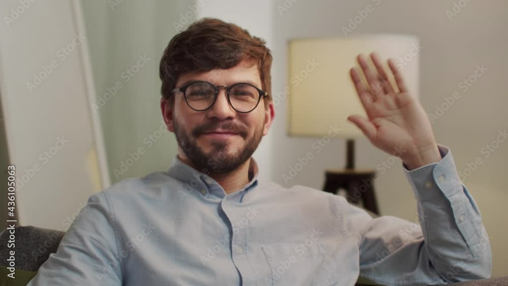 European happy man looks at the camera and waves his hand. European happy man looks at the camera and waves his hand.