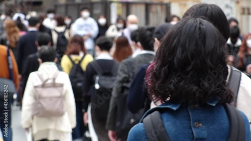 Wallpaper Mural OSAKA, JAPAN - APRIL 2021 : Back shot and unidentified crowd of people wearing surgical masks to protect from Coronavirus (COVID-19) at the street. Slow motion shot. In front focus. Torontodigital.ca