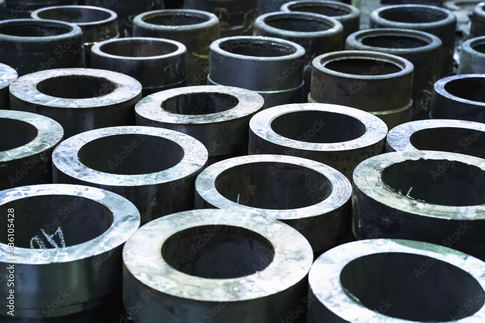 Finished metal cylindrical tubular pipe products in metal processing plant. Finished metal cylindrical tubular pipe products in metal processing plant.