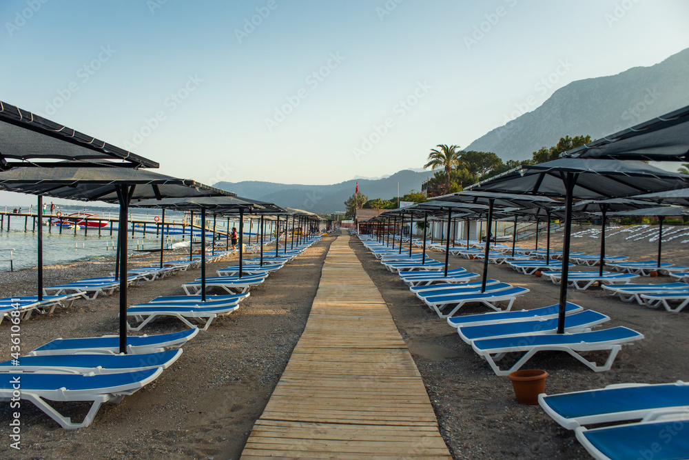 Row of empty sun loungers on the beach in Kemer Antalya