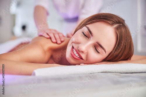 Happy cheerful Caucasian female enjoying spa day in spa resort hotel