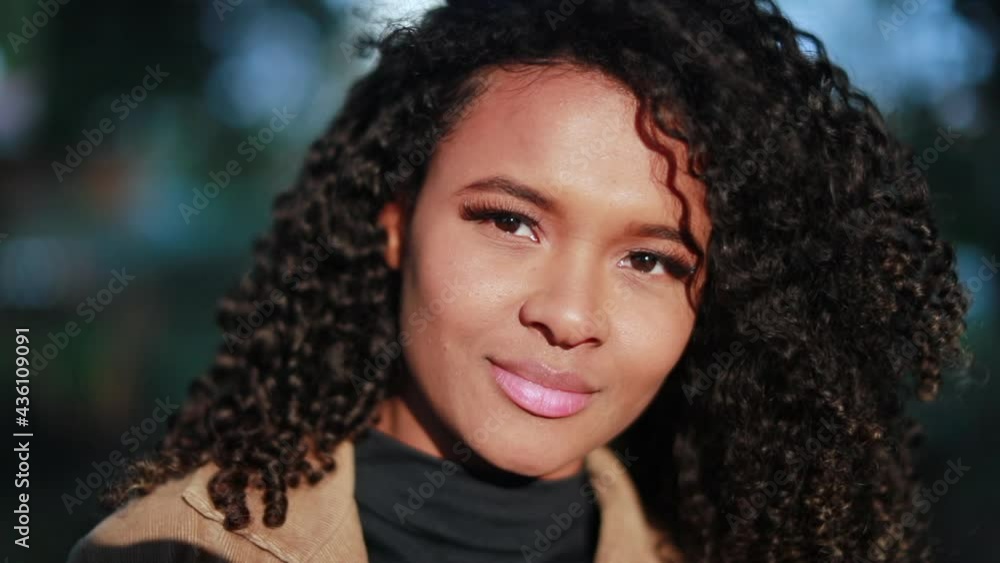 Young black woman, confident African girl smiling in sunlight Young black woman, confident African girl smiling in sunlight