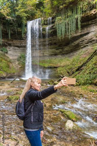 Tourist taking a selfie with the Cascade du Dard Nozon Gorge  near Croy-Romainm  tier  Canton Vaud  Switzerland.