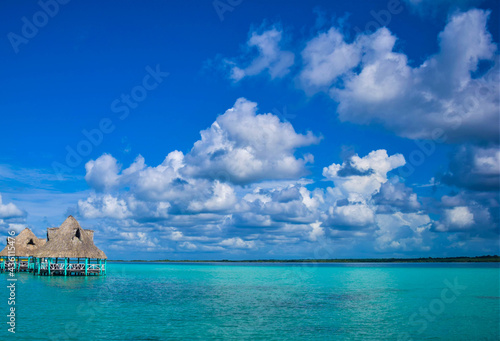 Canvastavla The turquoise lake of Bacalar with two floating palps in Mexico