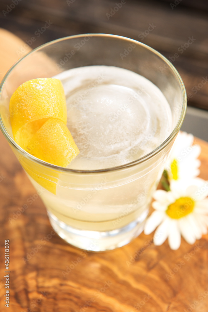 A Bee's Knees cocktail, vodka or gin with lemon and honey, garnished with lemon zest with some daisy's. A Bee's Knees cocktail, vodka or gin with lemon and honey, garnished with lemon zest with some daisy's.