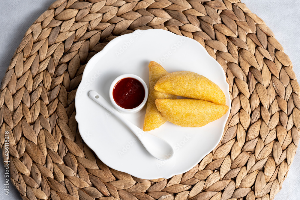 typical Colombian empanada served on a plate.
