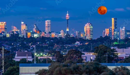 Photography Large orange moon rising behind Sydney CBD buildings NSW Australia