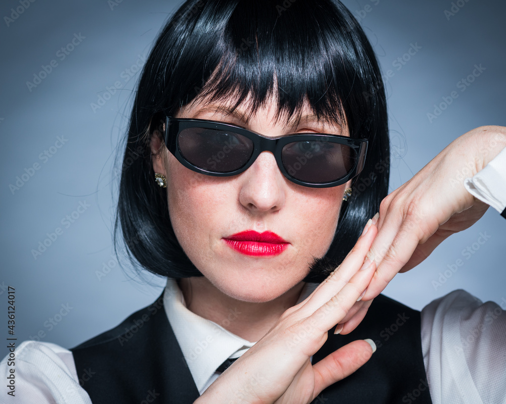 Cheeky Young Citizen with Black Hair, Dark Suit, Red Lips and Mysterious Shades. Cheeky Young Citizen with Black Hair, Dark Suit, Red Lips and Mysterious Shades.