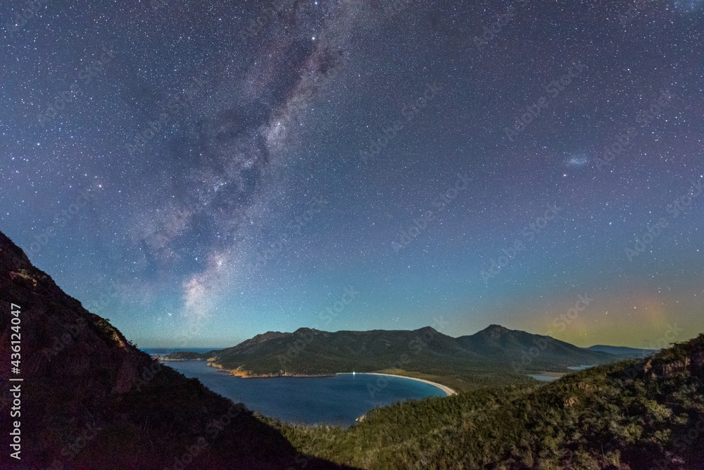 Milky Way and Aurora Australis over moonlit Wineglass Bay, Tasmania