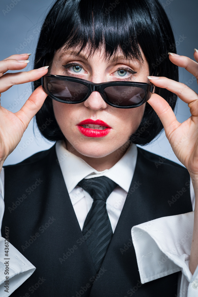 Cheeky Young Citizen with Black Hair, Dark Suit, Red Lips and Mysterious Shades. Cheeky Young Citizen with Black Hair, Dark Suit, Red Lips and Mysterious Shades.