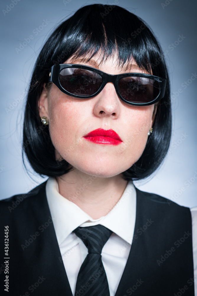 Cheeky Young Citizen with Black Hair, Dark Suit, Red Lips and Mysterious Shades. Cheeky Young Citizen with Black Hair, Dark Suit, Red Lips and Mysterious Shades.