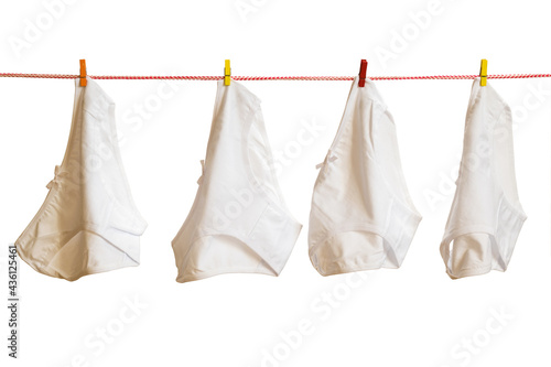 Four women's panties on a clothesline isolated on a white background.