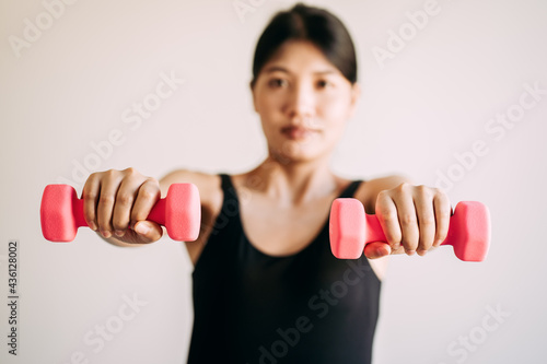 young women lifting dumbbell exercise at home, female doing workout sports indoors, healthy lifestyle concept.
