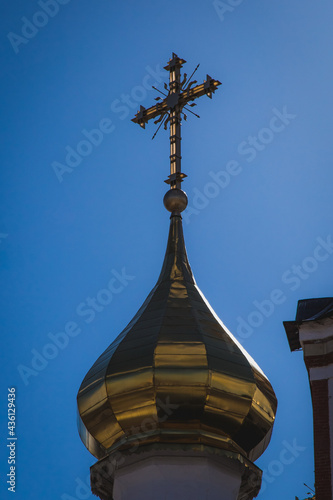 golden domes of the orthodox church with beautiful crosses at the top against the blue sky
