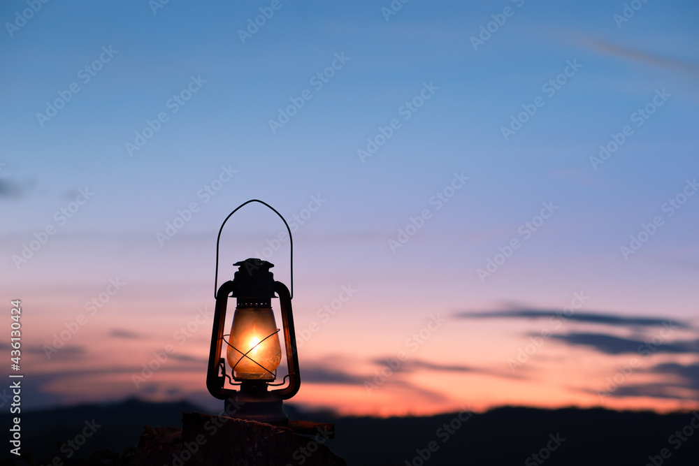 Kerosene lamp lit with a beautiful sky after sunset. Rustic lantern lit. Kerosene lamp lit with a beautiful sky after sunset. Rustic lantern lit.