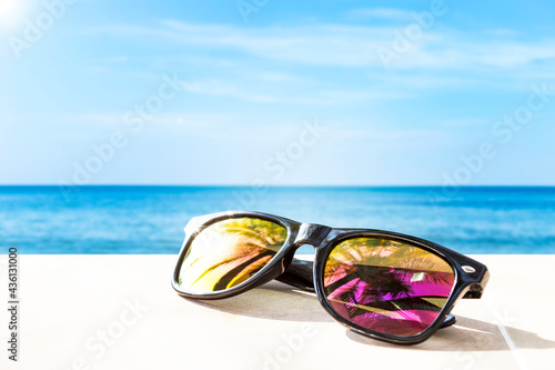 Sunglasses on the beach, summer fashion concept, outdoor day light, tropical holiday