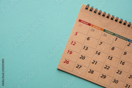 Close up of calendar on green background, planning for business meeting or travel planning concept