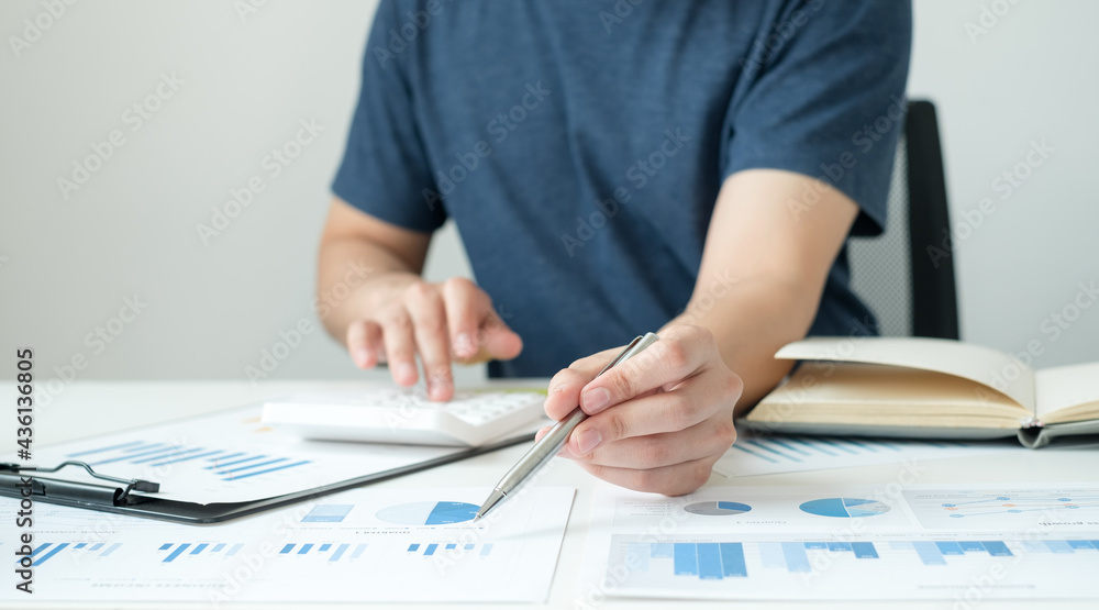 work from home, The hand of a man who works in finance sits at his desk at home and calculates financial graphs showing the results of his investments, planning the steps of his business growth work from home, The hand of a man who works in finance sits at his desk at home and calculates financial graphs showing the results of his investments, planning the steps of his business growth