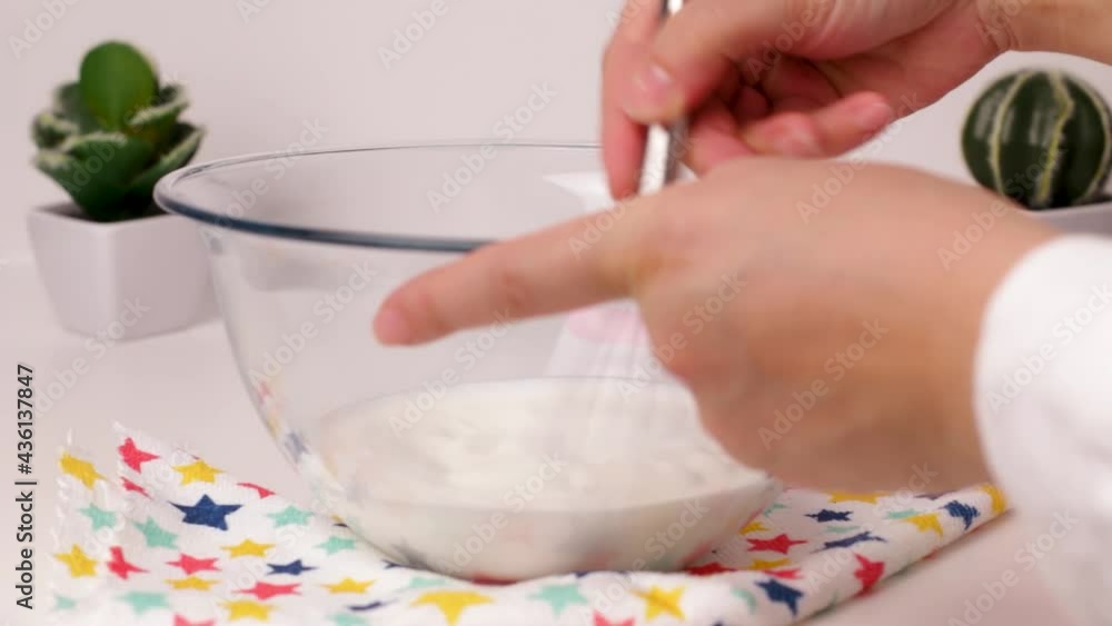 Fast mixing dairy product to prepare homemade ice cream, close up view Fast mixing dairy product to prepare homemade ice cream, close up view