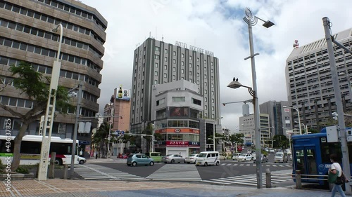 NAHA, OKINAWA, JAPAN - MAY 2021 : View around central downtown area Kokusaidori street. Busy touristic area in Okinawa. Many souvenir shop, restaurant and bar at the street. photo