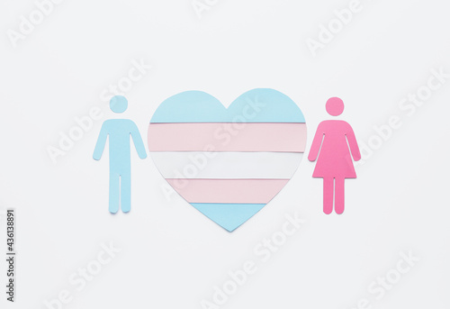 Flag of transgender in shape of heart, male and female figures on white background