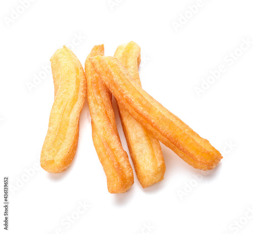 Tasty churros on white background