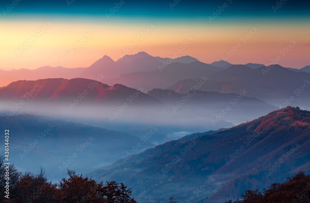 Dramatic autumn sunrise in Carpathian mountains. Colorful morning scene of foggy mountain valley. Beauty of nature concept background..