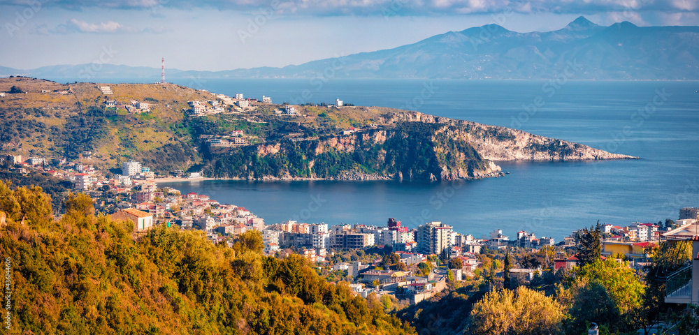Panoramic spring cityscape of Himara town, Vlore, Albania, Europe. Sunny evening seascape of Adriatic sea. Traveling concept background..