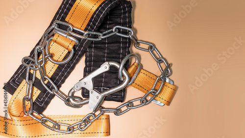 Safety belt for work at height with carabiner. Professional safety equipment for mountaineering and construction. Safety precautions. Close-up. © Anoo