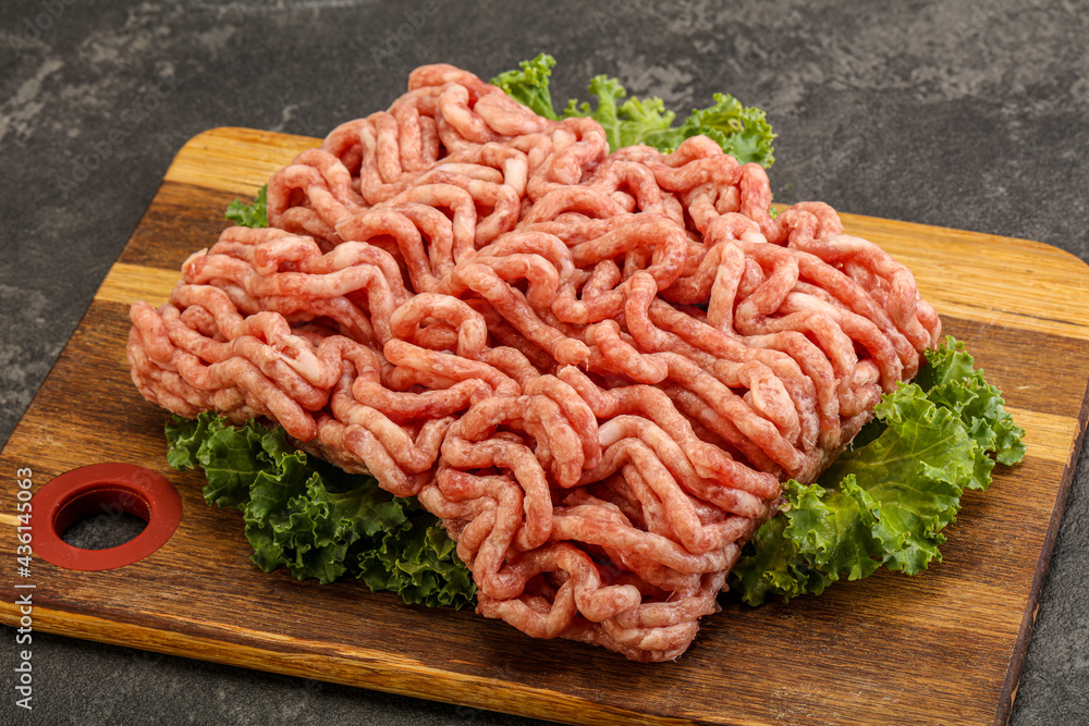 Raw pork minced meat over board Raw pork minced meat over board
