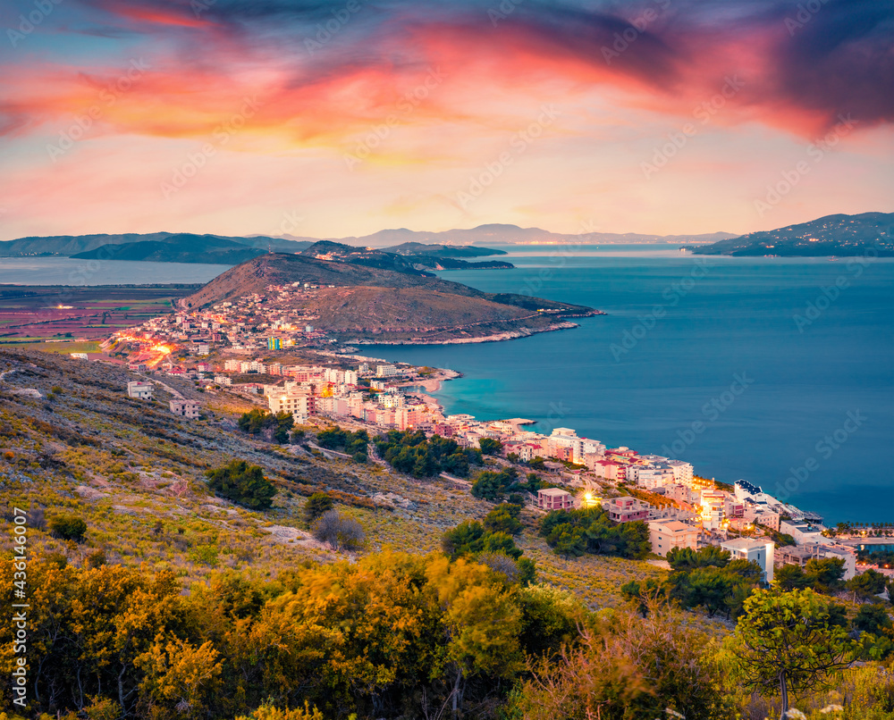 Aerial morning cityscape of Saranda port. Stunning sunrise on Ionian sea. Picturesque outdoor scene of Albania, view from Lekursi Castle. Traveling concept background.
