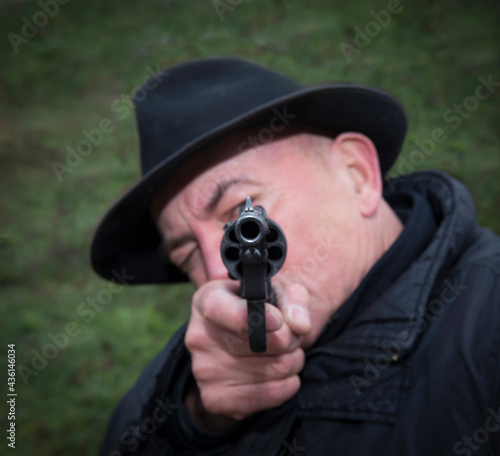 Man aiming a gun Nagan © Aleksandr