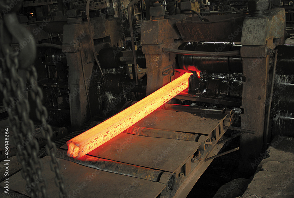 red hot steel bars are being rolled to different sizes in a rolling