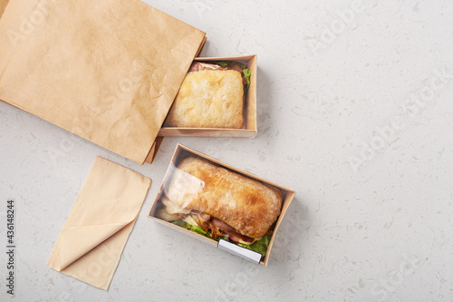 Sandwich with ciabatta bread in takeout or delivery food container photo