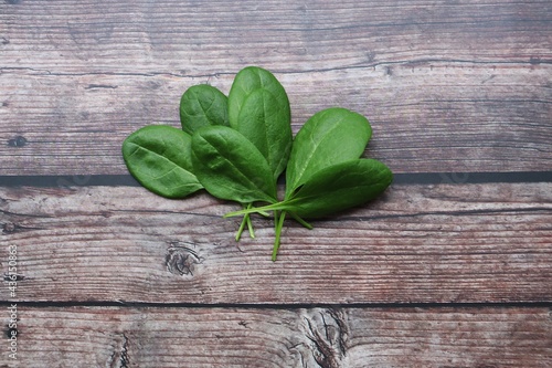 fresh spinach leaves on a wooden background