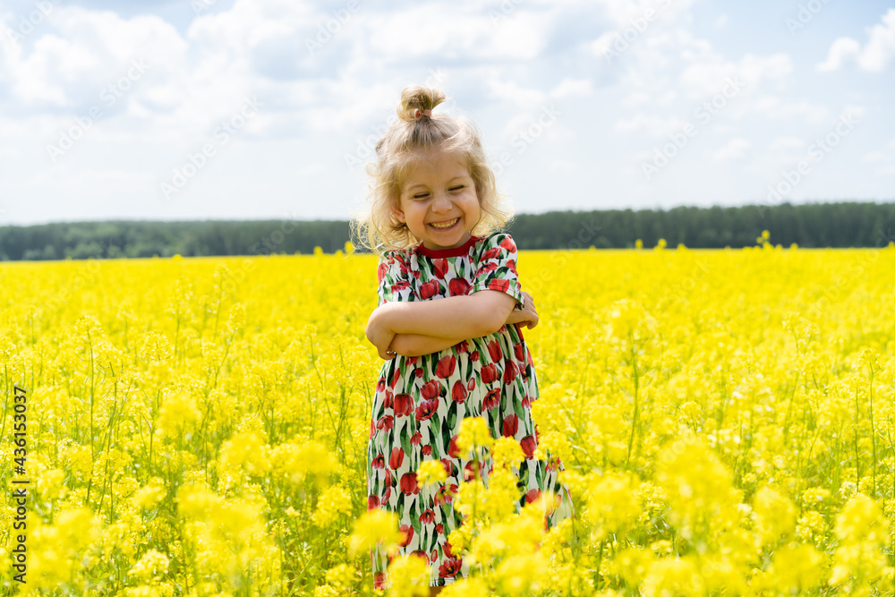 little blonde girl in a field of rape, happy baby in a field of flowers little blonde girl in a field of rape, happy baby in a field of flowers