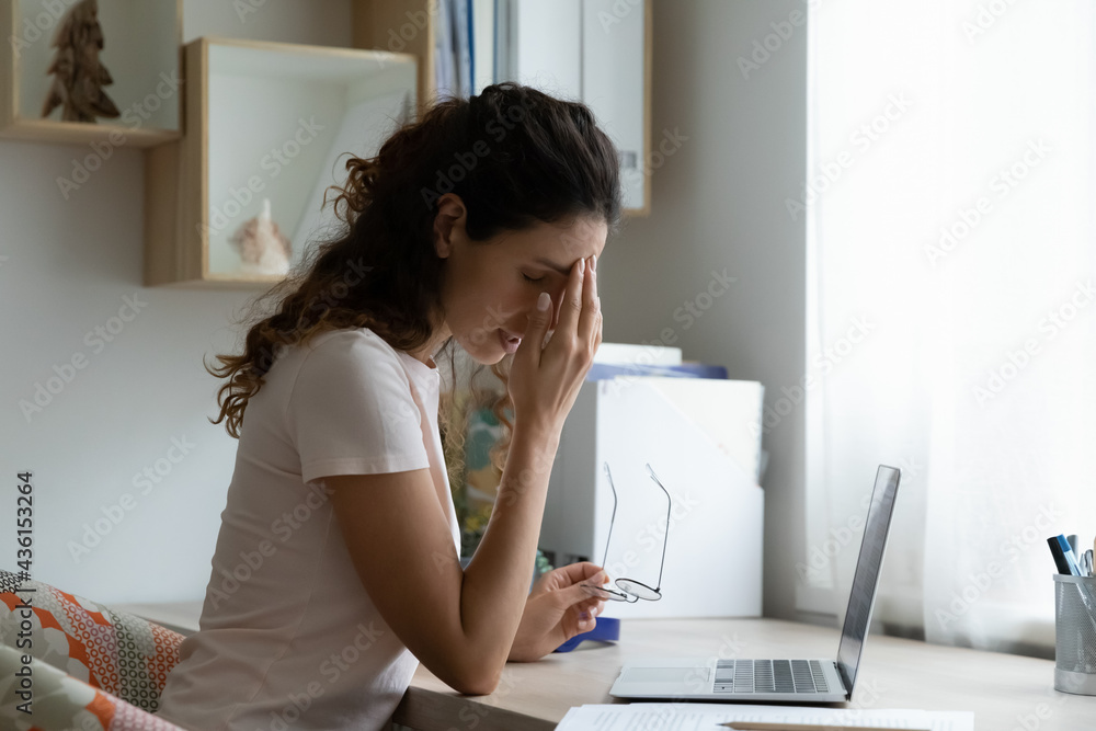 Overwhelmed young woman taking off glasses, suffering from dry eyes syndrome or painful feelings due to long computer overwork. Stressed millennial hispanic latin lady needs rest after hard workday, Overwhelmed young woman taking off glasses, suffering from dry eyes syndrome or painful feelings due to long computer overwork. Stressed millennial hispanic latin lady needs rest after hard workday,