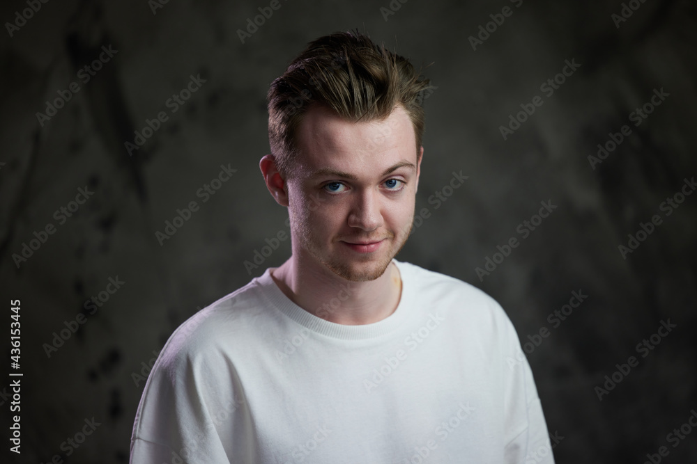 Portrait of a young caucasian man on a gray background Portrait of a young caucasian man on a gray background