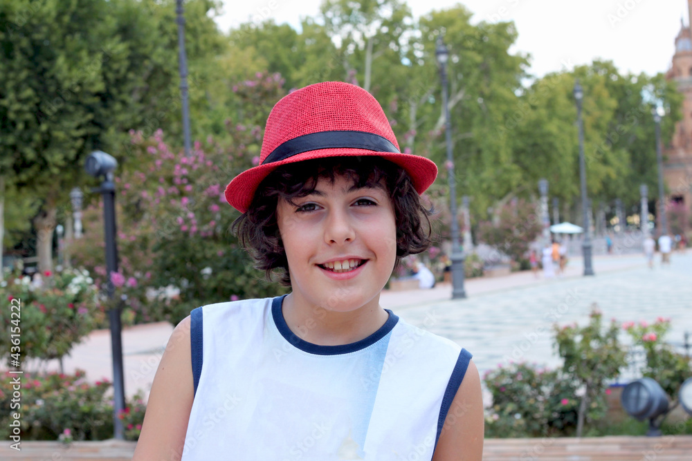 portrait of a young boy in a red  hat smiling at camera