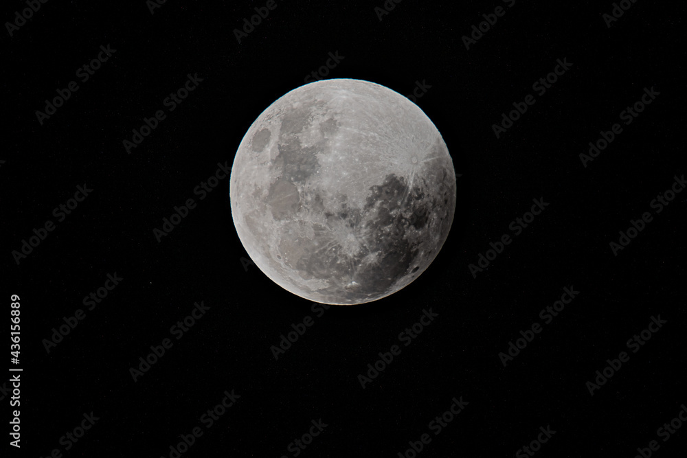 Fototapeta premium Full Moon and Lunar Eclipse begins with a slight shadowing on the moon
