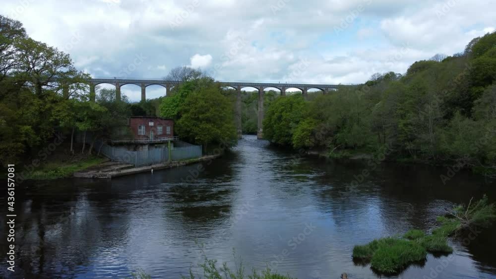Fresh flowing scenic canal aqueduct pump house woodland countryside aerial rising view to bridge Fresh flowing scenic canal aqueduct pump house woodland countryside aerial rising view to bridge