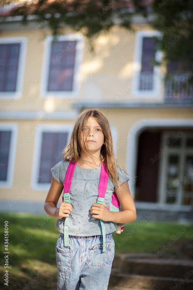 Little girl leaving school building. Little girl leaving school building.