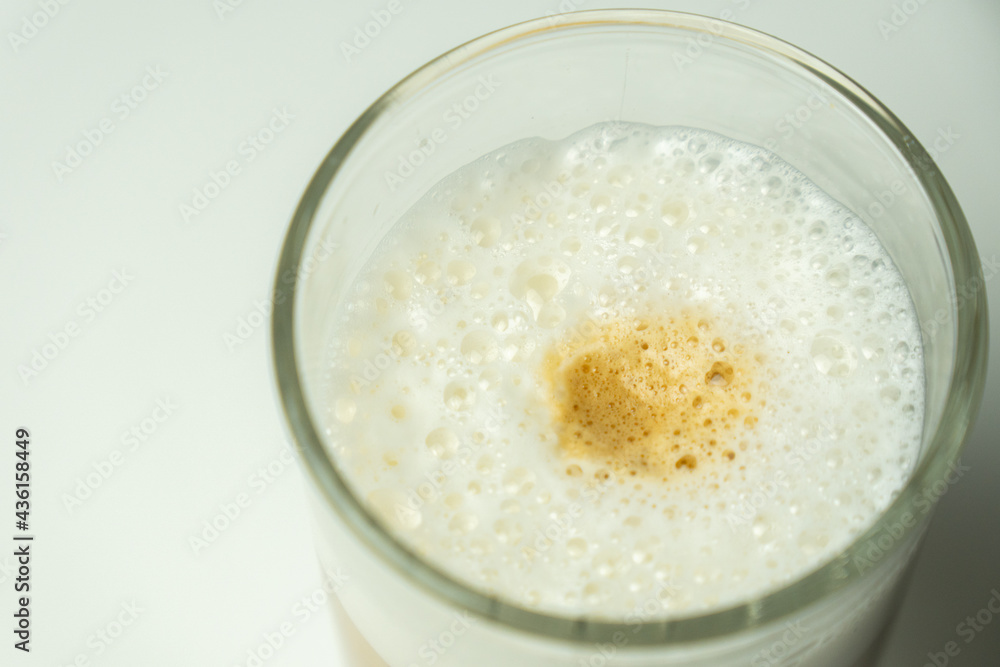Glass of latte coffee on light background Glass of latte coffee on light background