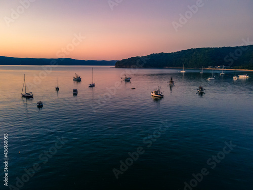 Boats at rest and gentle sunrise over the bay